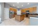 Bright kitchen with stainless steel appliances, center island, tile flooring, and modern lighting at 13100 Lakewind Dr, Clermont, FL 34711