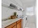 Bright laundry room with tile flooring, washer, dryer, utility sink and overhead shelving at 13100 Lakewind Dr, Clermont, FL 34711