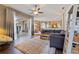 Bright living room featuring wood floors, ceiling fan, and a patio door to the outdoor space at 13100 Lakewind Dr, Clermont, FL 34711