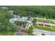 An aerial view shows community amenities including pool, clock tower, clubhouse, lake, and lush landscaping at 14421 Vashons Way, Winter Garden, FL 34787