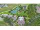 An aerial view of community amenities, including a pool, clubhouse, tennis court, basketball court, and playground at 14421 Vashons Way, Winter Garden, FL 34787