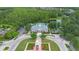 An aerial view shows community amenities, including pool, clock tower, clubhouse, and lush landscaping at 14421 Vashons Way, Winter Garden, FL 34787
