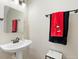 Pedestal sink and Mickey Mouse towels in this charming bathroom at 14421 Vashons Way, Winter Garden, FL 34787