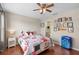 Bedroom features ceiling fan, hardwood floors and natural light at 14421 Vashons Way, Winter Garden, FL 34787