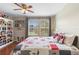 Bedroom with wood floors, bright windows, and matching bedding at 14421 Vashons Way, Winter Garden, FL 34787
