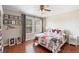 Bedroom features hardwood floors, ceiling fan and cozy quilt at 14421 Vashons Way, Winter Garden, FL 34787