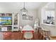 Dining area features modern lighting, white and orange chairs, and seamless access to the kitchen at 14421 Vashons Way, Winter Garden, FL 34787