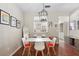 Well-lit dining room with a modern table set and an open view into the kitchen at 14421 Vashons Way, Winter Garden, FL 34787