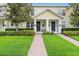 Charming townhome with a well-maintained lawn, brick walkway, and inviting front porch at 14421 Vashons Way, Winter Garden, FL 34787