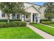 Charming townhome with a well-maintained lawn, brick walkway, and inviting front porch at 14421 Vashons Way, Winter Garden, FL 34787