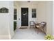 Inviting front porch with two chairs, decorative door wreath, and a welcome mat at 14421 Vashons Way, Winter Garden, FL 34787