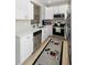 Bright kitchen showcasing stainless steel appliances, modern faucet, and tiled backsplash at 14421 Vashons Way, Winter Garden, FL 34787