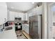 Updated kitchen with stainless steel appliances, white cabinets, and tiled backsplash at 14421 Vashons Way, Winter Garden, FL 34787