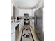 Well-lit kitchen featuring stainless steel appliances and white cabinets at 14421 Vashons Way, Winter Garden, FL 34787