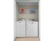 Functional laundry room featuring white appliances and ample shelving for storage at 14421 Vashons Way, Winter Garden, FL 34787