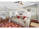 Open-concept living room with a large sectional sofa, adjacent dining area, and staircase access at 14421 Vashons Way, Winter Garden, FL 34787