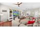 Cozy living room with hardwood floors, a comfortable sectional sofa, and a large entertainment center at 14421 Vashons Way, Winter Garden, FL 34787