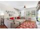 Comfortable living room with a large sectional sofa, hardwood floors, and natural light from the windows at 14421 Vashons Way, Winter Garden, FL 34787