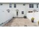 A private patio with brick pavers and a white privacy fence offers an inviting outdoor space at 14421 Vashons Way, Winter Garden, FL 34787