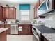 Stylish kitchen with stainless steel appliances, granite countertops, white backsplash, and ample cabinet space at 1454 Westbury Dr, Clermont, FL 34711