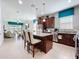 Modern kitchen with stainless steel appliances, granite countertops, island with seating, and bright lighting at 1454 Westbury Dr, Clermont, FL 34711