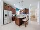 Modern kitchen featuring a center island with seating, stainless steel appliances, and plenty of cabinet space at 1454 Westbury Dr, Clermont, FL 34711