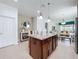 Spacious kitchen with granite island, stainless steel appliances, and open access to living and dining areas at 1454 Westbury Dr, Clermont, FL 34711