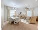 Open-concept living space with dining area, plush seating, elegant décor, and plenty of natural light at 1454 Westbury Dr, Clermont, FL 34711