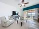 Inviting living room with tile flooring, slider to patio and comfortable white seating at 1454 Westbury Dr, Clermont, FL 34711