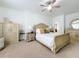 Bright main bedroom with neutral tones, carpet, and classic bedroom furniture at 1454 Westbury Dr, Clermont, FL 34711