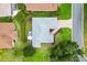 Aerial shot of a well-kept home with a paved driveway, manicured lawn, and outdoor patio area at 1514 Vandam St, The Villages, FL 32162