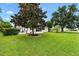 Well-maintained home featuring a manicured lawn and a cozy patio area for outdoor relaxation at 1514 Vandam St, The Villages, FL 32162