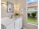 Well-lit bathroom featuring a clean vanity and modern fixtures and a window at 1514 Vandam St, The Villages, FL 32162
