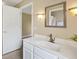 Bright bathroom with a white vanity, decorative mirror, and modern lighting fixtures at 1514 Vandam St, The Villages, FL 32162