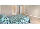 Bright bedroom featuring a comfortable bed, closet and a view to outside at 1514 Vandam St, The Villages, FL 32162