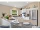 Close up of kitchen with stainless appliances and island seating at 1514 Vandam St, The Villages, FL 32162
