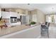 Bright kitchen features stainless steel appliances, white cabinets, and a breakfast bar with seating at 1514 Vandam St, The Villages, FL 32162