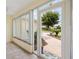 Enclosed lanai with tiled floor, offering peaceful views of the landscaped front yard at 1514 Vandam St, The Villages, FL 32162
