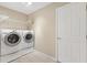 Laundry room with washer, dryer, and storage shelving at 1514 Vandam St, The Villages, FL 32162