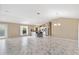 Open-concept living area with marble-look tile flooring and a view into the kitchen at 1514 Vandam St, The Villages, FL 32162