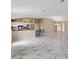 This inviting living space seamlessly connects the kitchen and living area with elegant flooring at 1514 Vandam St, The Villages, FL 32162