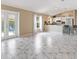 The bright living space opens to an outdoor area via a glass door, complemented by tile floors at 1514 Vandam St, The Villages, FL 32162
