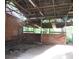 Rustic barn interior showcasing a wooden frame, aged walls, and natural lighting at 15587 Se 150Th Ave, Weirsdale, FL 32195