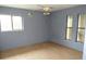 Bedroom with hardwood floors, three windows, and space themed decor, presenting an opportunity for customization and improvement at 15587 Se 150Th Ave, Weirsdale, FL 32195