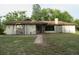 Single-story home showcasing a ranch-style design with a brown roof, neutral paint, and a stone accent at 15587 Se 150Th Ave, Weirsdale, FL 32195