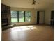 Spacious living room with hardwood floors, a stone fireplace, and a large window for natural light at 15587 Se 150Th Ave, Weirsdale, FL 32195