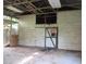 Large shed with corrugated metal walls and a side door, providing a spacious area for storage or renovation at 15587 Se 150Th Ave, Weirsdale, FL 32195