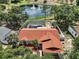 Aerial view of home with screened pool, overlooking a scenic pond with fountain at 15837 Hidden Lake Cir, Clermont, FL 34711