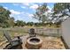 Charming backyard fire pit area with Adirondack chairs and a picturesque view of the pond at 15837 Hidden Lake Cir, Clermont, FL 34711