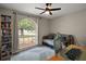 Cozy bedroom with a large window for natural light, a bookcase, and a comfortable daybed at 15837 Hidden Lake Cir, Clermont, FL 34711
